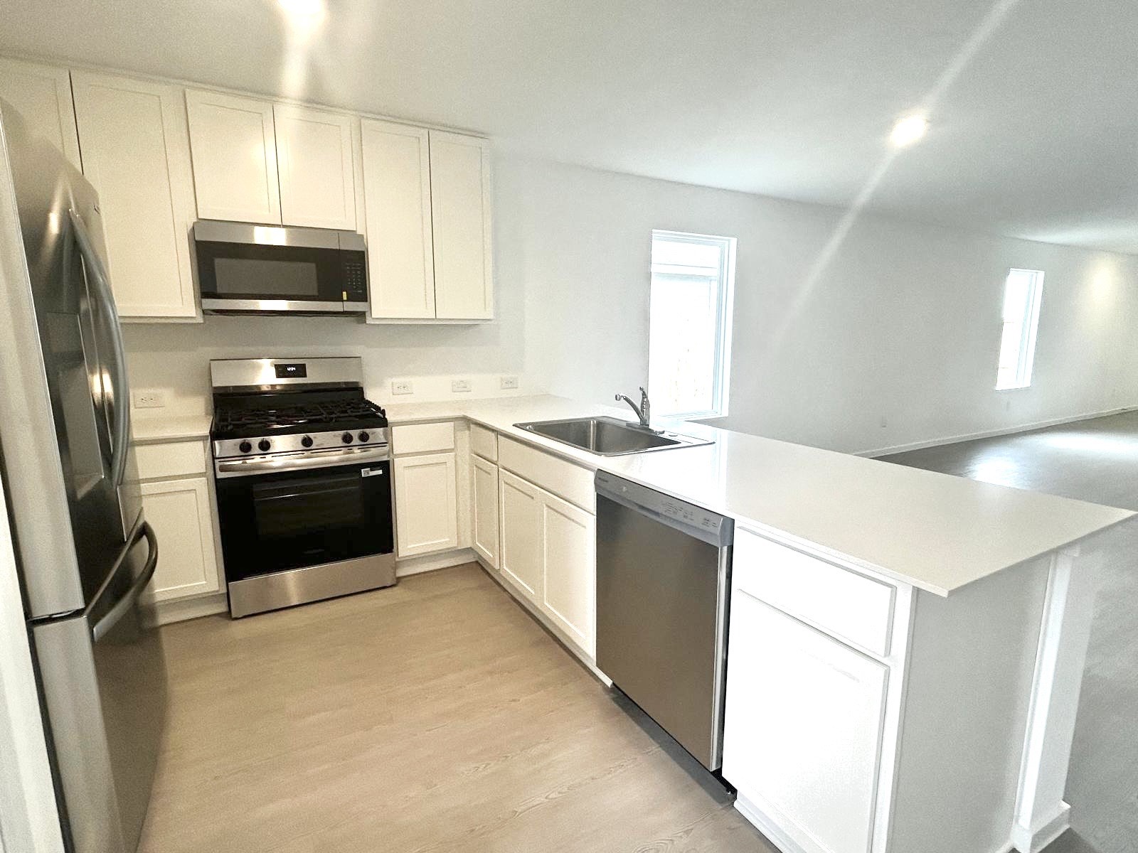 438 Southern Magnolia Way Magnolia, TX 77354 - Photo 3 of 18 a kitchen with a sink a stove and a refrigerator