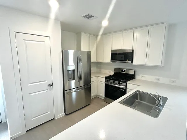 a kitchen with a refrigerator stove and microwave