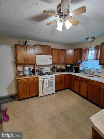 a kitchen with stainless steel appliances granite countertop a refrigerator and a stove