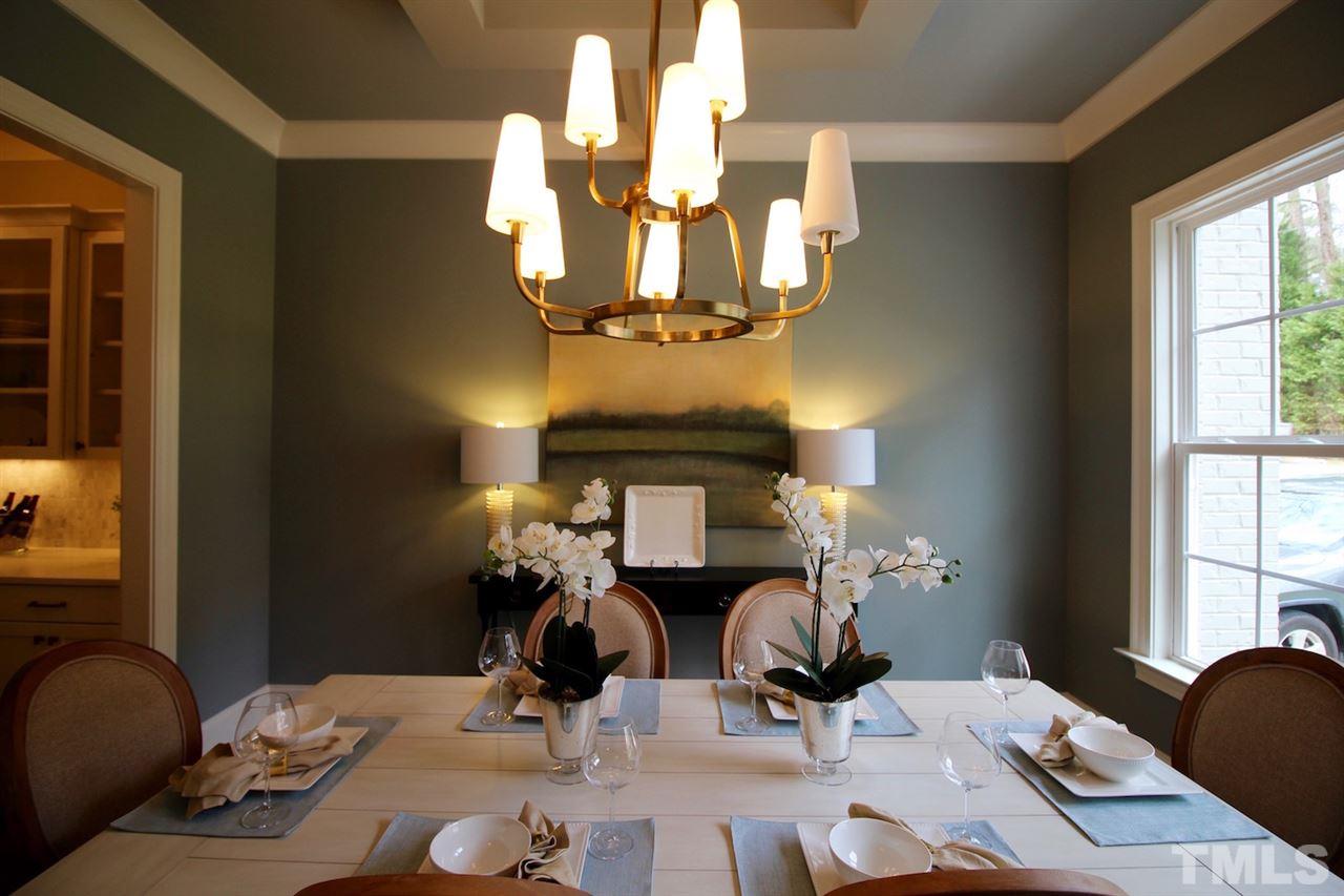 3013 Club Drive Raleigh, NC 27613 - Photo 3 of 25 a view of a dining room with furniture a chandelier and wooden floor