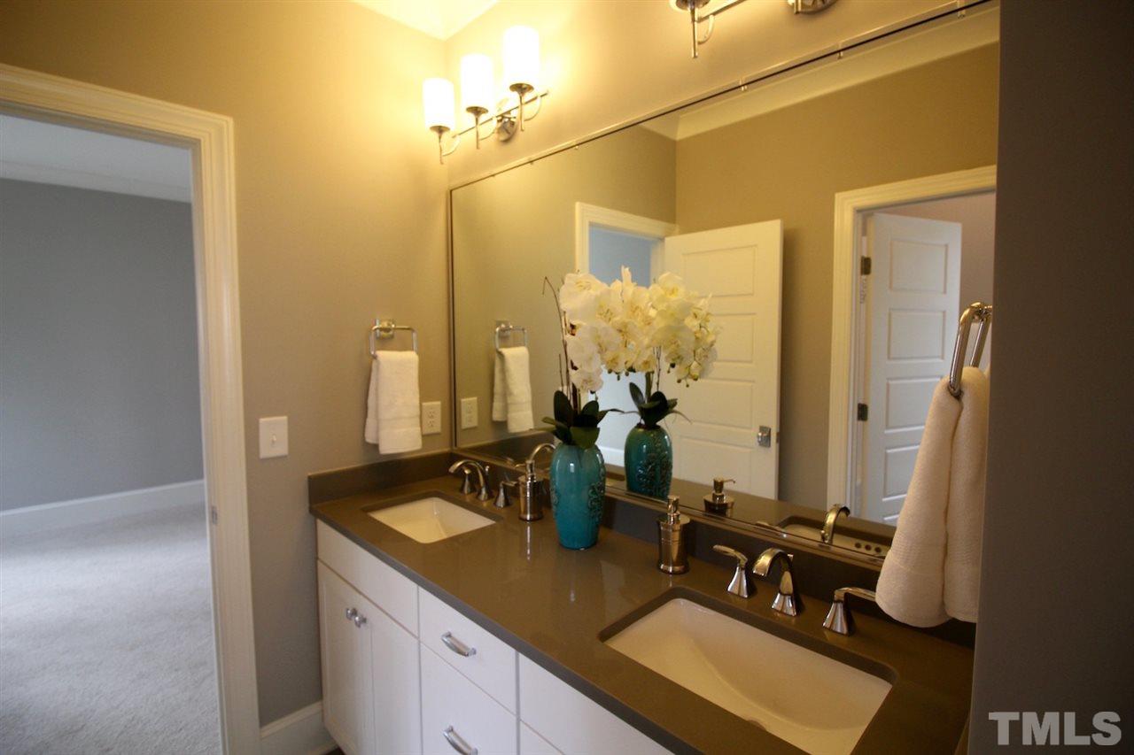 3013 Club Drive Raleigh, NC 27613 - Photo 22 of 25 a bathroom with a sink vanity and mirror