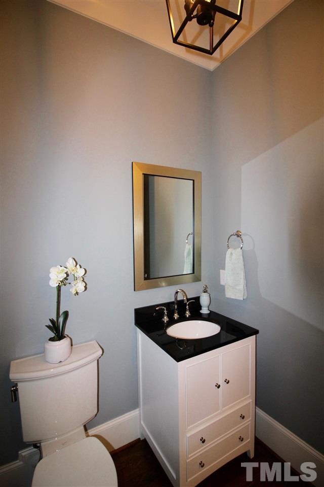 3013 Club Drive Raleigh, NC 27613 - Photo 6 of 25 a bathroom with a sink toilet and mirror