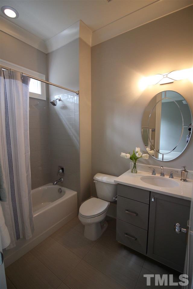 3013 Club Drive Raleigh, NC 27613 - Photo 7 of 25 a bathroom with a toilet sink and mirror