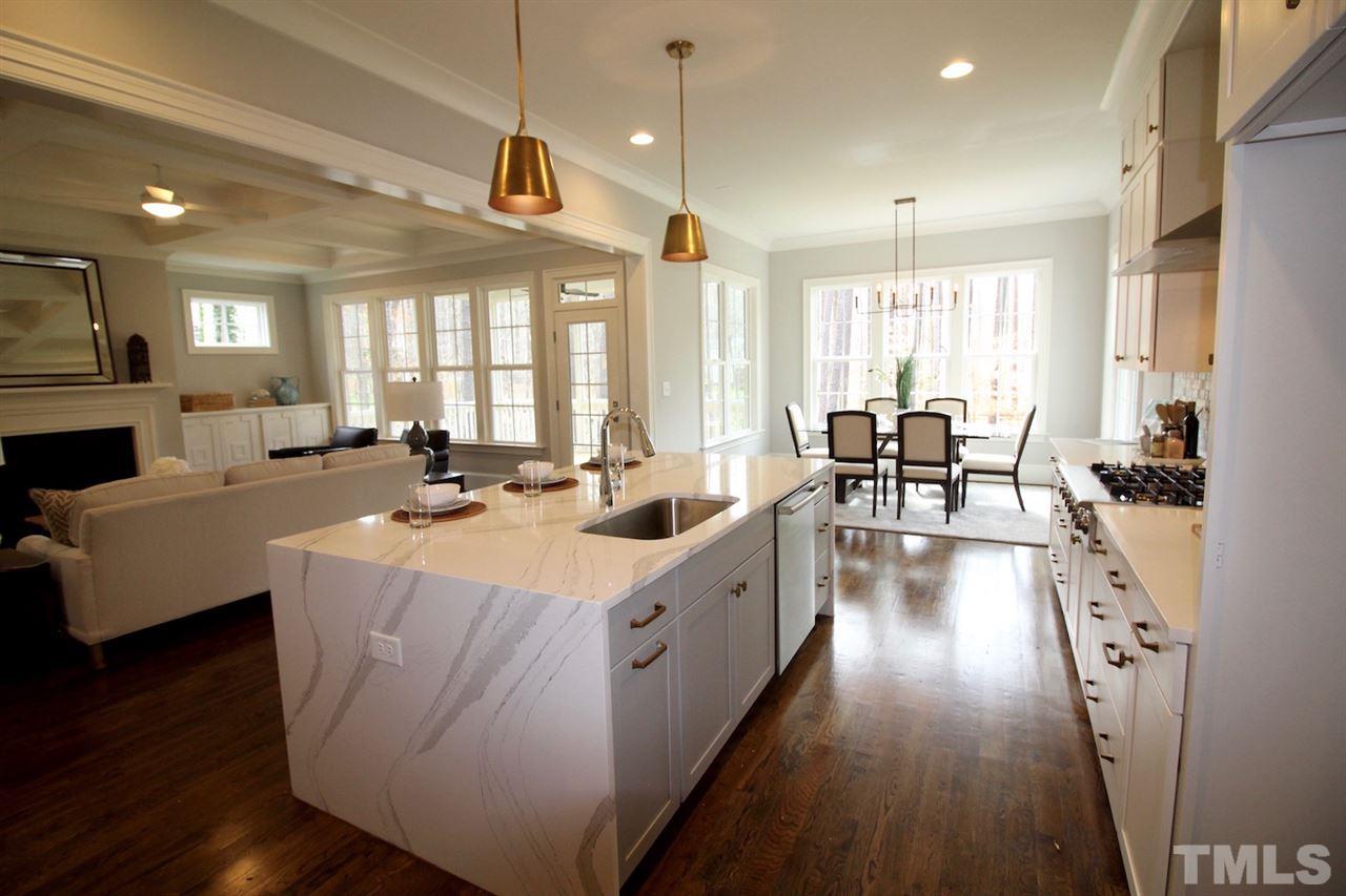 3013 Club Drive Raleigh, NC 27613 - Photo 8 of 25 a large white kitchen with lots of counter space dining table and chairs