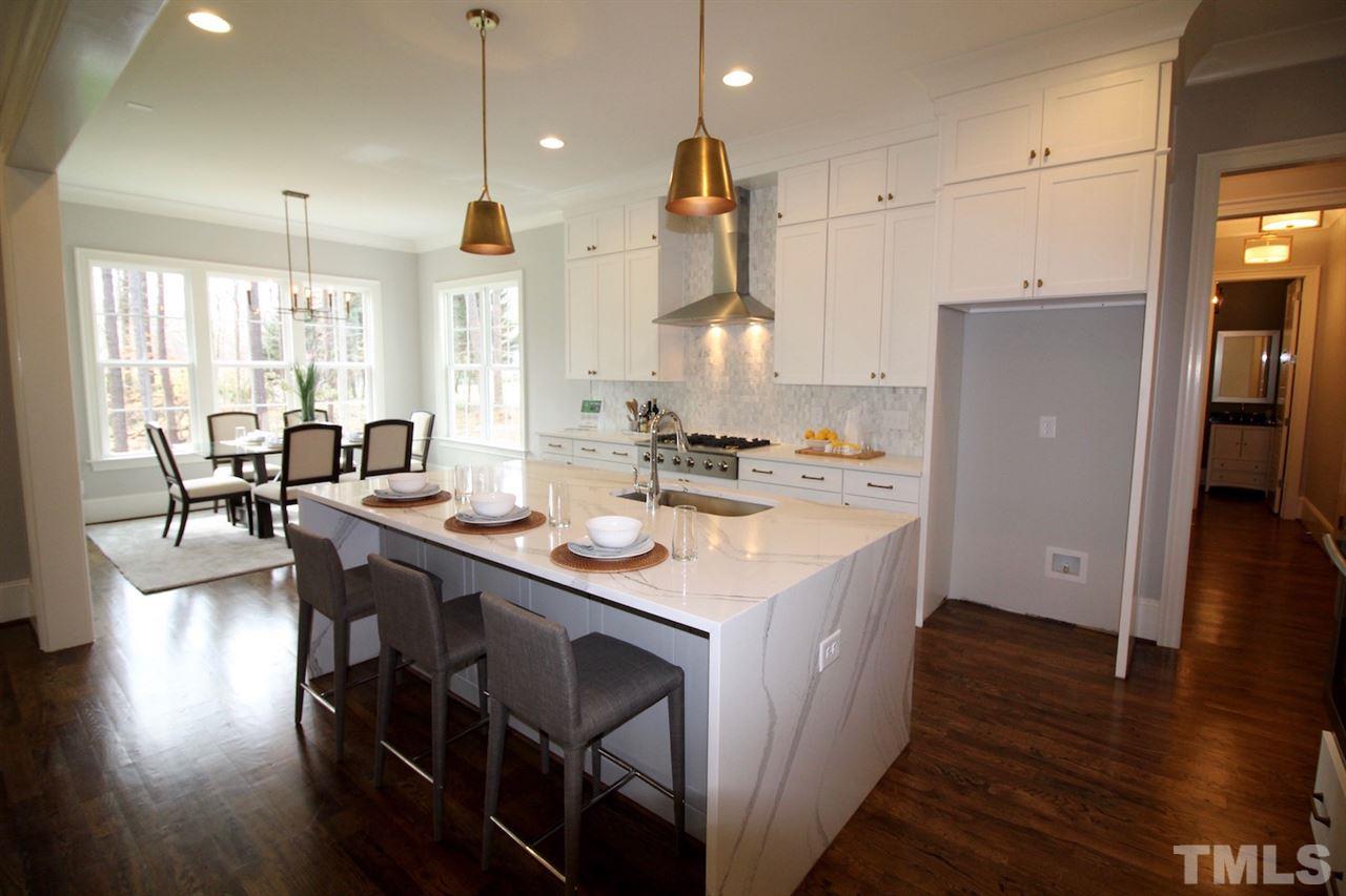 3013 Club Drive Raleigh, NC 27613 - Photo 9 of 25 a kitchen with stainless steel appliances granite countertop a sink a stove and a refrigerator
