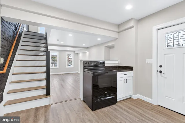 a view of kitchen and hall with wooden floor