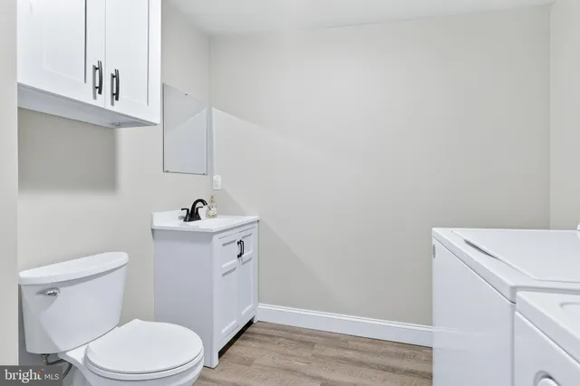 a bathroom with a sink a toilet and vanity