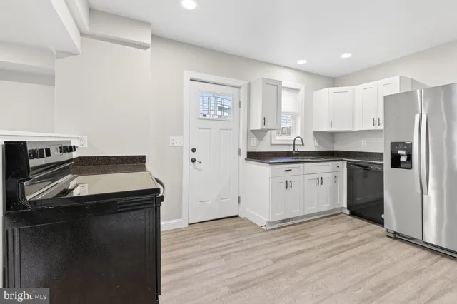 a kitchen with a sink stove and refrigerator