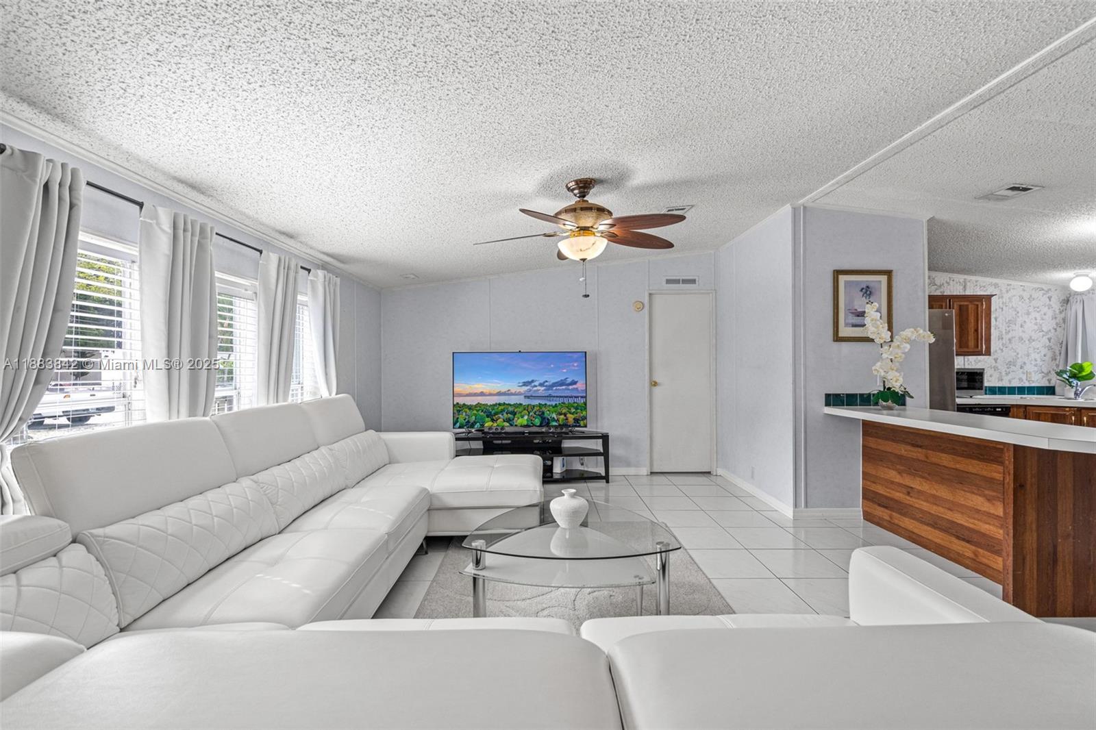 278 King Avenue Key Largo, FL 33037 - Photo 13 of 58 a living room with furniture a couch and a flat screen tv