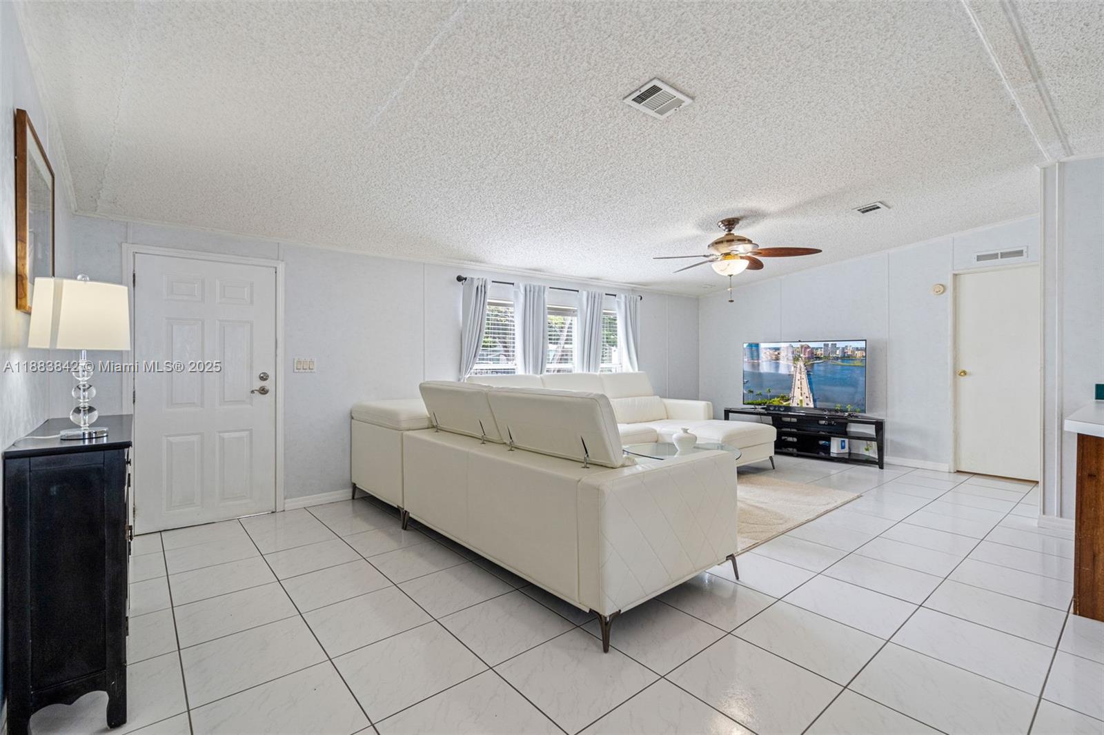 278 King Avenue Key Largo, FL 33037 - Photo 14 of 58 a living room with furniture and a chandelier