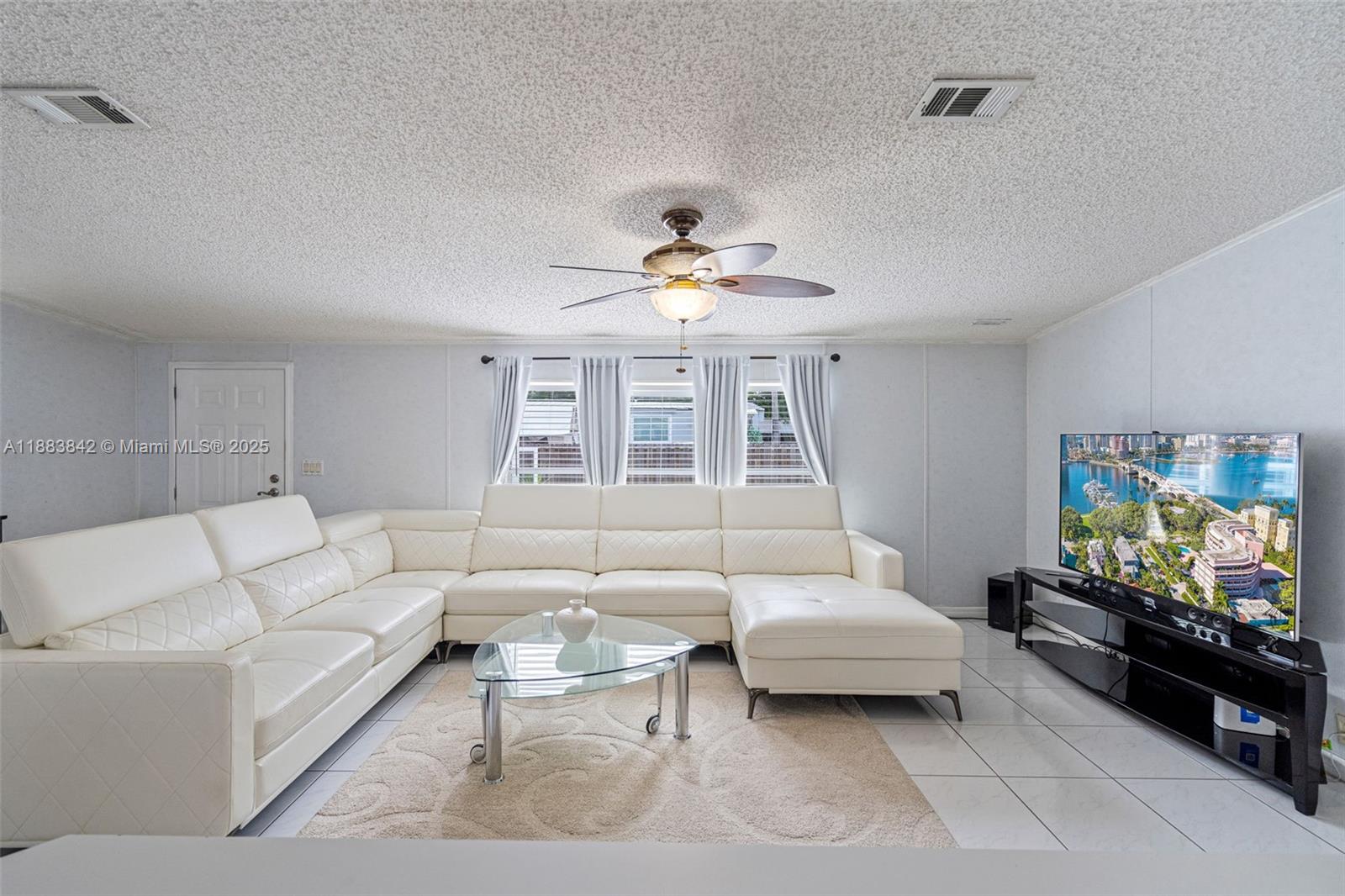 278 King Avenue Key Largo, FL 33037 - Photo 15 of 58 a living room with furniture and a flat screen tv