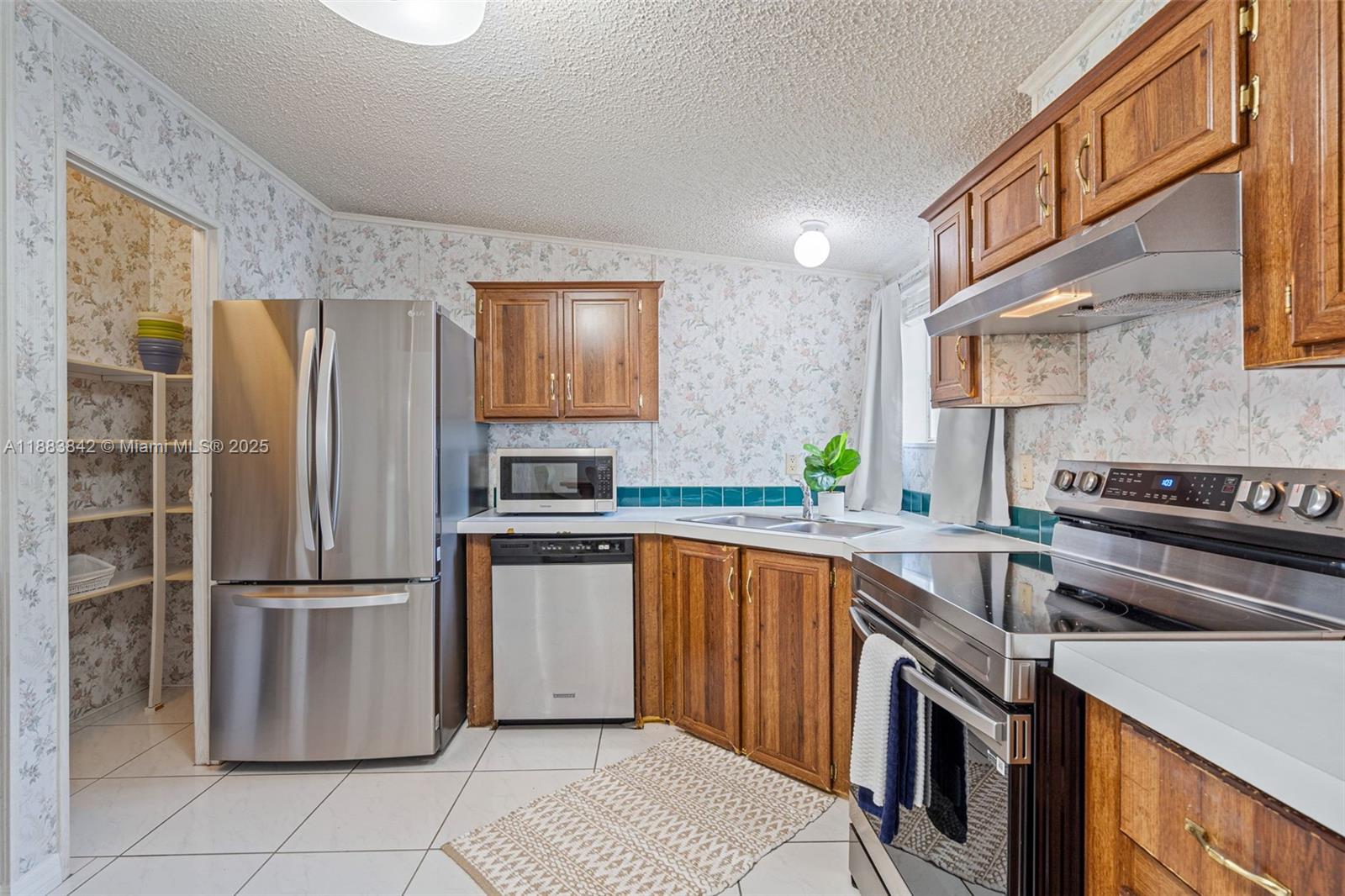 278 King Avenue Key Largo, FL 33037 - Photo 22 of 58 a kitchen with stainless steel appliances granite countertop a refrigerator a sink a stove and island