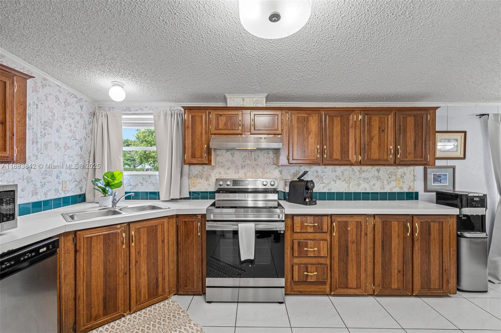 278 King Avenue Key Largo, FL 33037 - Photo 23 of 58 a kitchen with granite countertop a stove top oven sink and cabinets