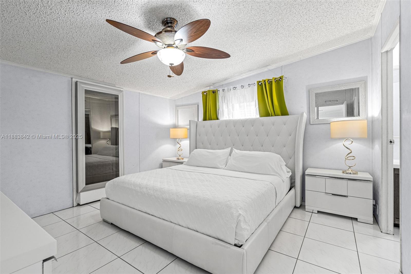 278 King Avenue Key Largo, FL 33037 - Photo 25 of 58 a bedroom with a large bed and a chandelier
