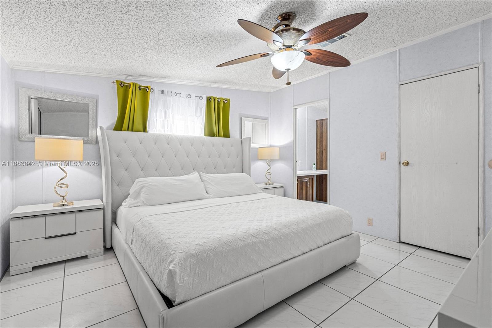278 King Avenue Key Largo, FL 33037 - Photo 26 of 58 a bedroom with a bed and a chandelier