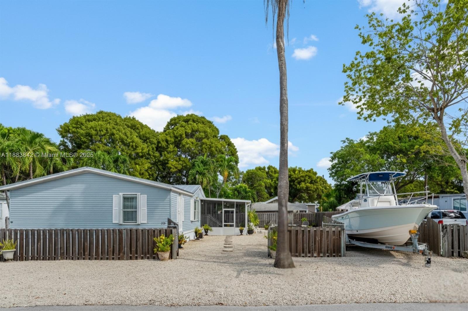 278 King Avenue Key Largo, FL 33037 - Photo 3 of 58 a view of a chairs and table in the back yard of the house