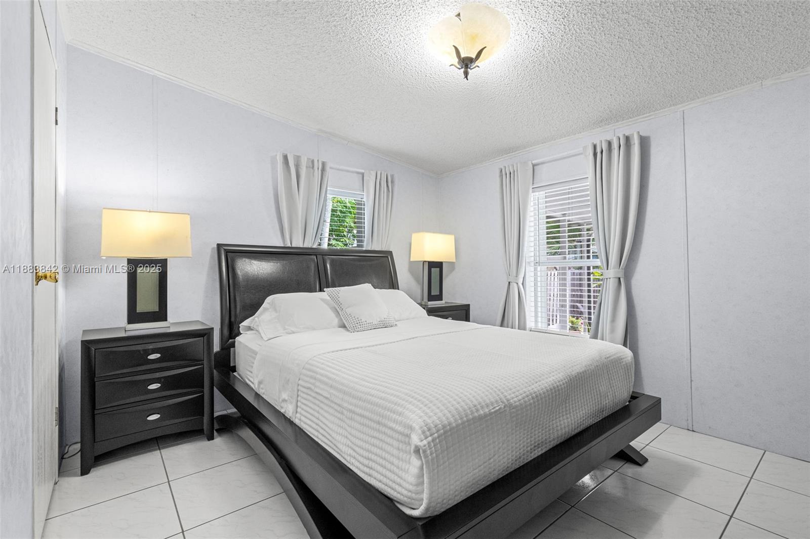 278 King Avenue Key Largo, FL 33037 - Photo 37 of 58 a bedroom with a bed and a night stand