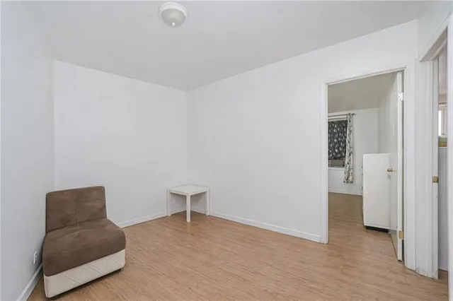 a kitchen with cabinets stainless steel appliances and wooden floor