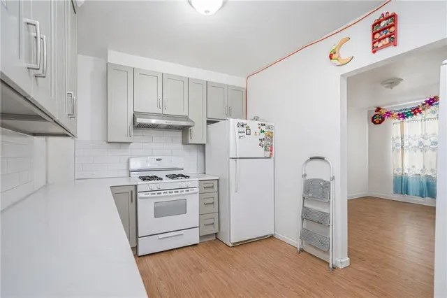 a kitchen with a white cabinets and white appliances