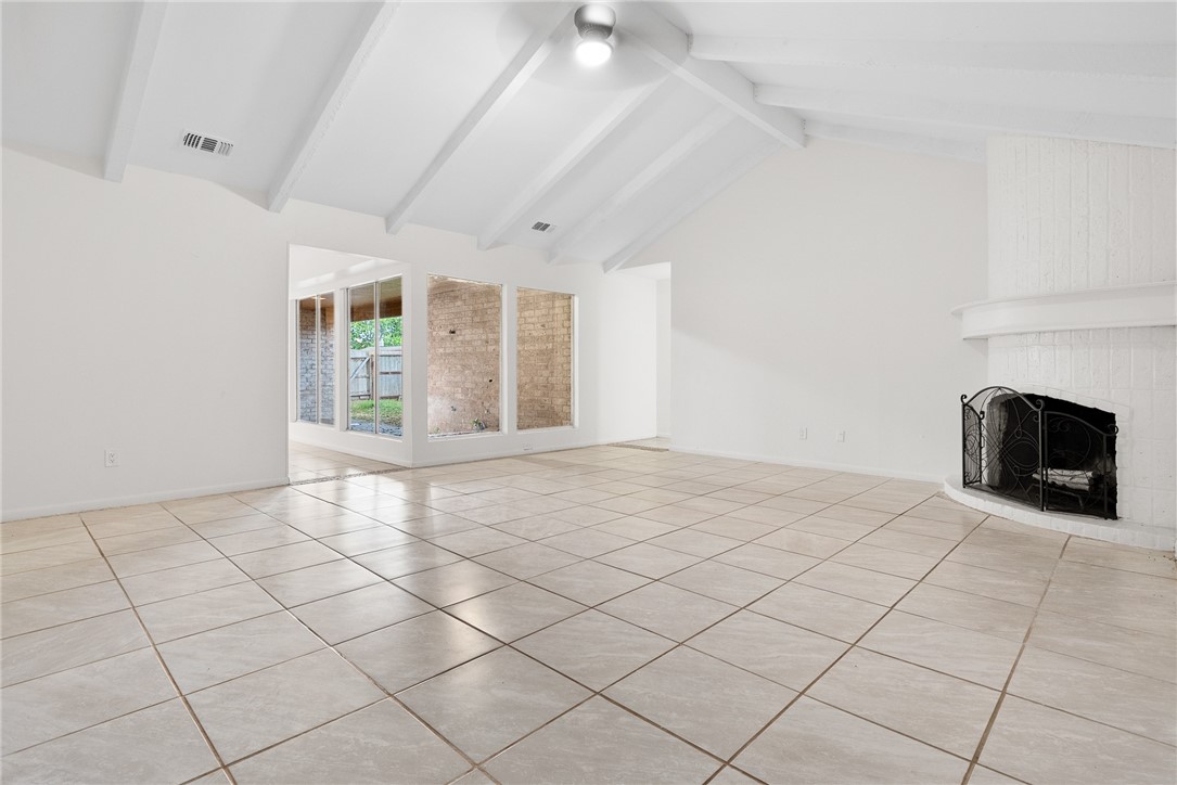 5009 Wingfoot Lane, Unit B Corpus Christi, TX 78413 - Photo 4 of 23 an empty room with windows and fireplace