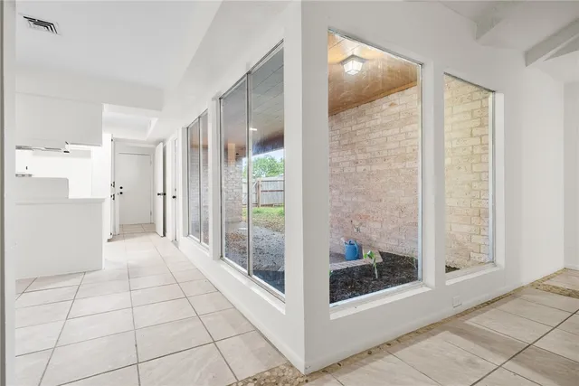 a view of a kitchen with a dishwasher and white cabinets