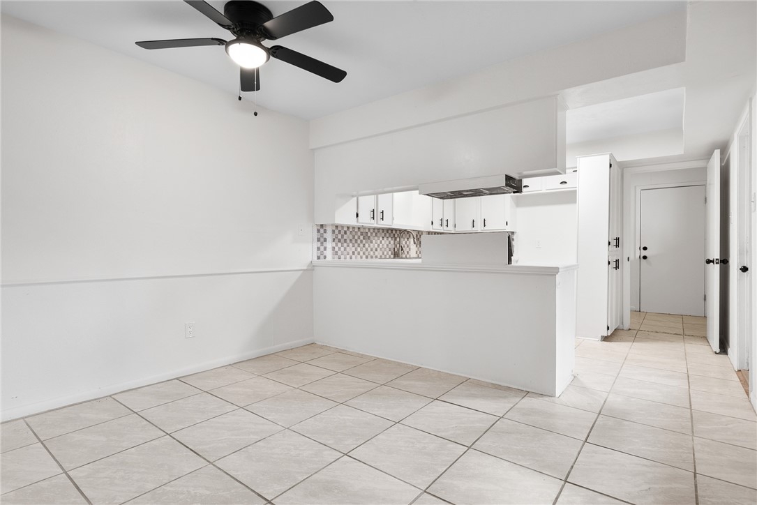 5009 Wingfoot Lane, Unit B Corpus Christi, TX 78413 - Photo 8 of 23 a view of a kitchen with a dishwasher and white cabinets