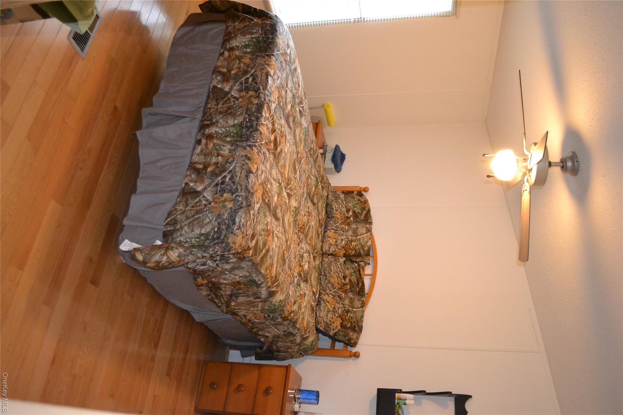 144 Bonnie Brook Road Roscoe, NY 12776 - Photo 13 of 34 Bedroom with light wood-style flooring, ceiling fan, and a textured ceiling