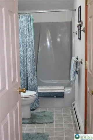 a bathroom with a toilet and shower