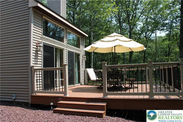 a view of a chair and tables in the balcony