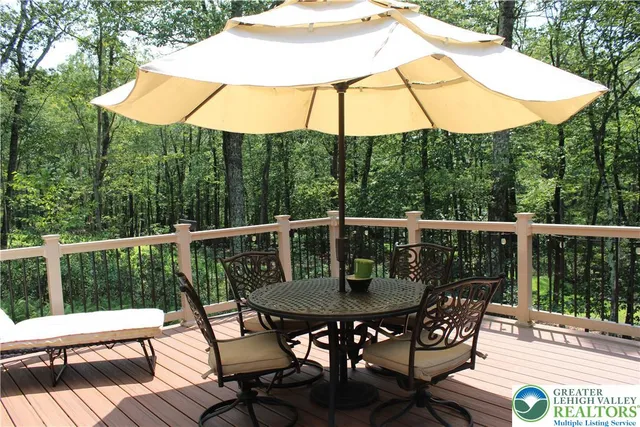 a view of balcony with furniture and umbrella