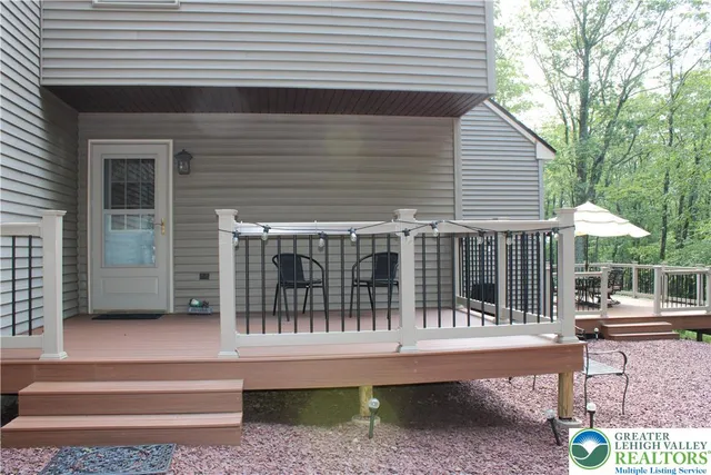 a view of a house with a balcony and wooden floor