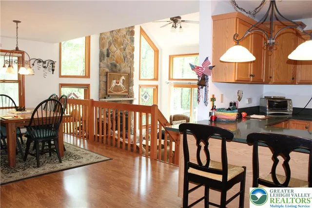 a dining room with furniture a chandelier and wooden floor