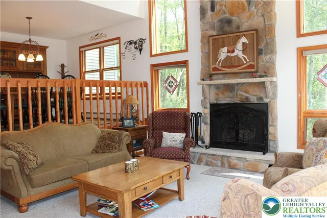 a living room with furniture a fireplace and a window