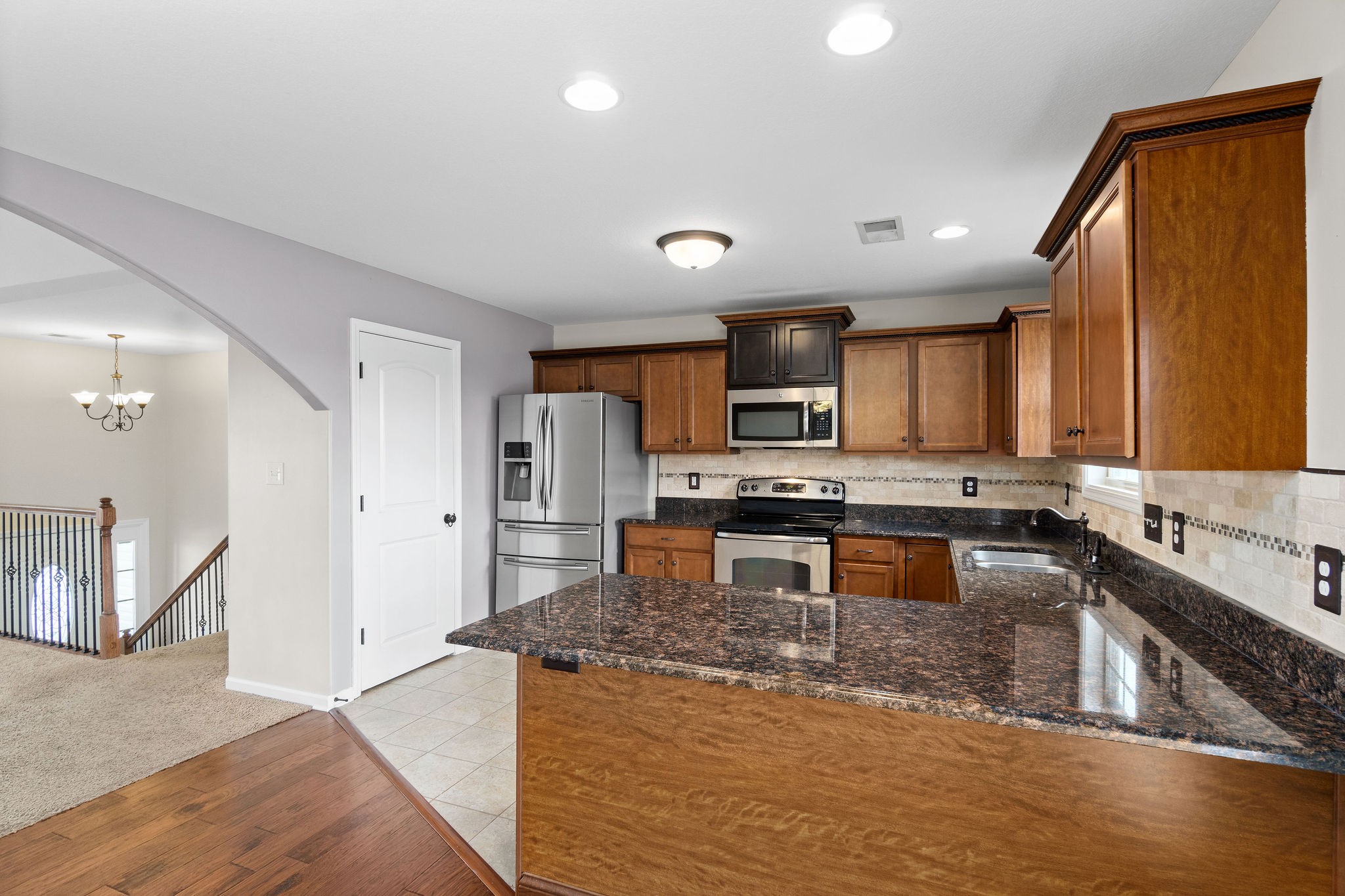3768 Suiter Road Clarksville, TN 37040 - Photo 12 of 28 a kitchen with stainless steel appliances granite countertop a sink stove and refrigerator