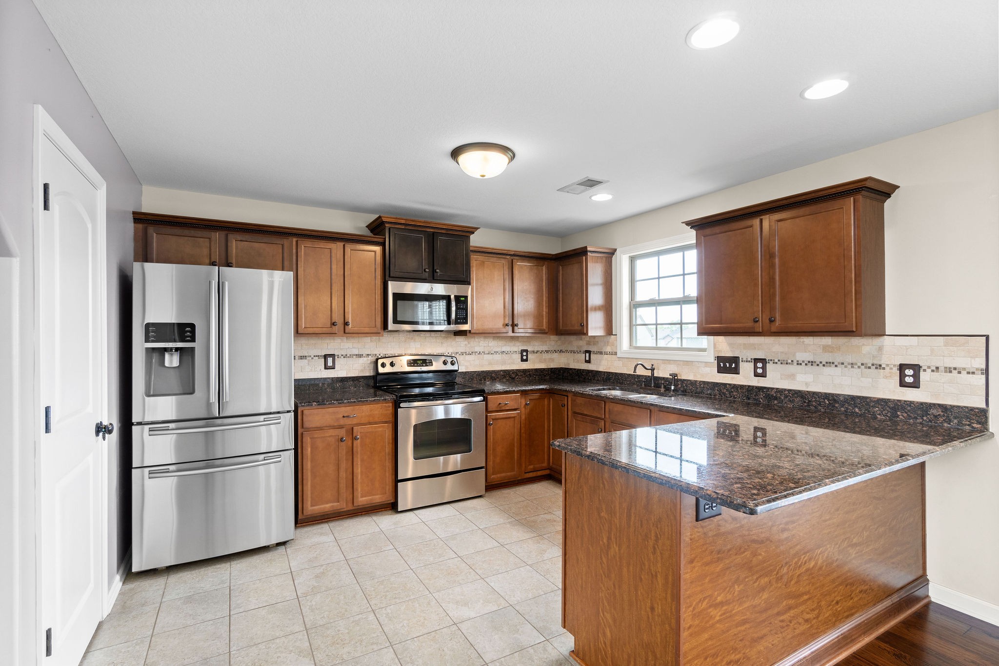 3768 Suiter Road Clarksville, TN 37040 - Photo 13 of 28 a kitchen with stainless steel appliances granite countertop a refrigerator sink and stove