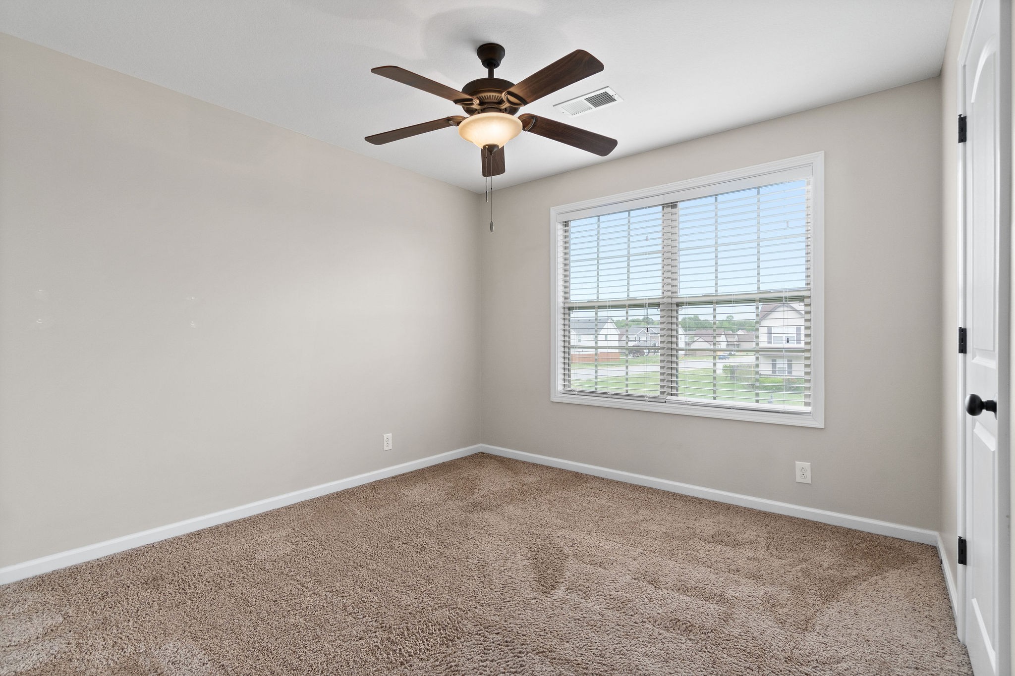 3768 Suiter Road Clarksville, TN 37040 - Photo 22 of 28 an empty room with ceiling fan and windows