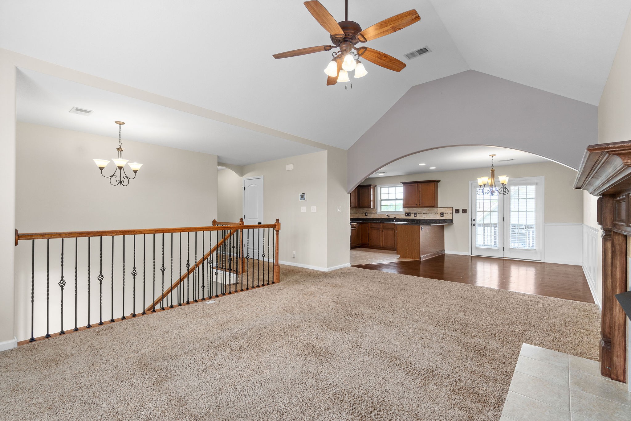 3768 Suiter Road Clarksville, TN 37040 - Photo 9 of 28 wooden floor in a room with a chandelier fan and kitchen view