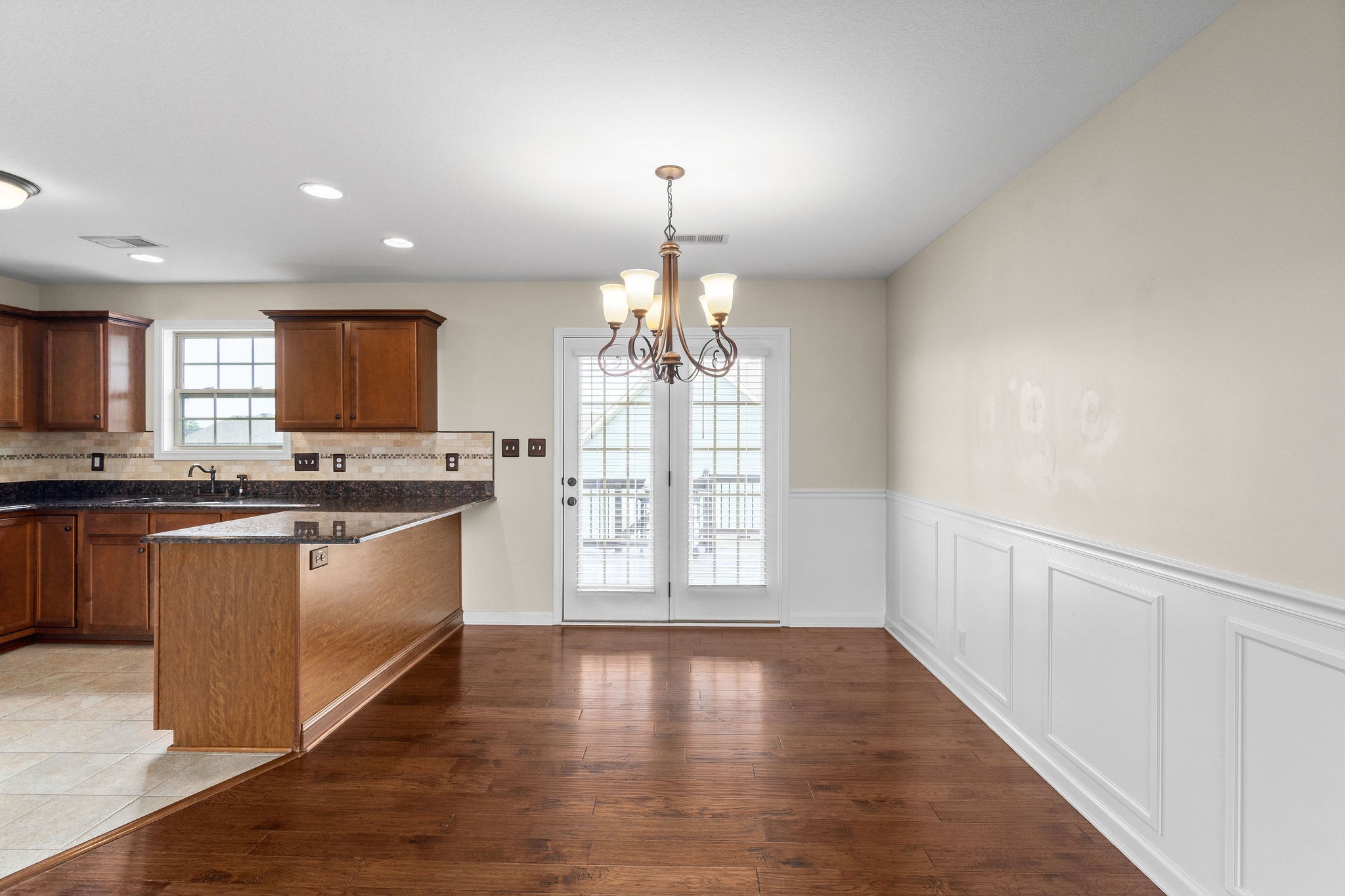 3768 Suiter Road Clarksville, TN 37040 - Photo 10 of 28 a open kitchen with granite countertop a stove top oven a sink dishwasher and white cabinets with wooden floor
