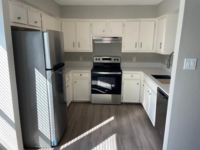 10616 Mellow Meadow Drive, Unit 43C Austin, TX 78750 - Photo 1 of 9 a kitchen with a refrigerator stove and wooden cabinets