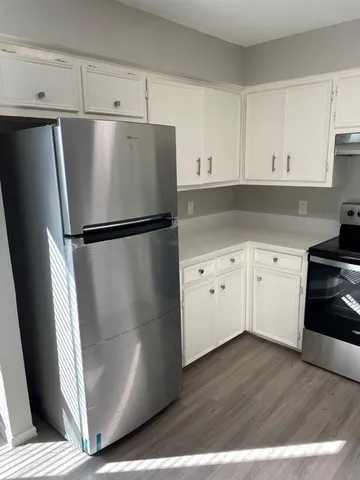 a white refrigerator freezer sitting in a kitchen