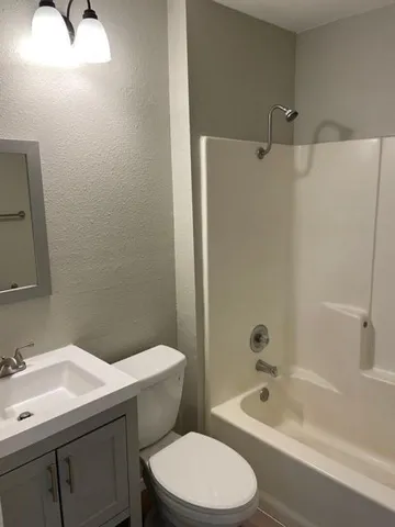 a bathroom with a sink a toilet and bathtub