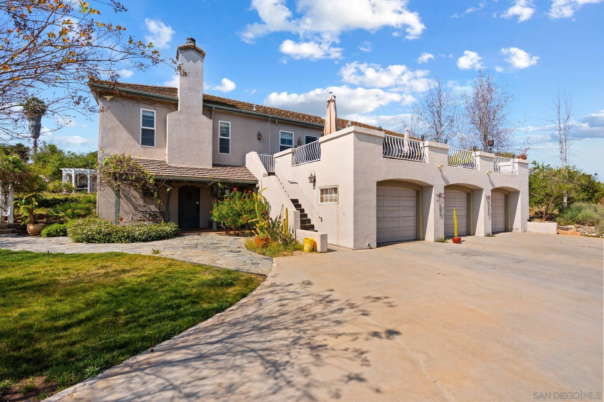 1035 Sleeping Indian Road Oceanside, CA 92057 - Photo 20 of 22 a view of a house with a yard and garage
