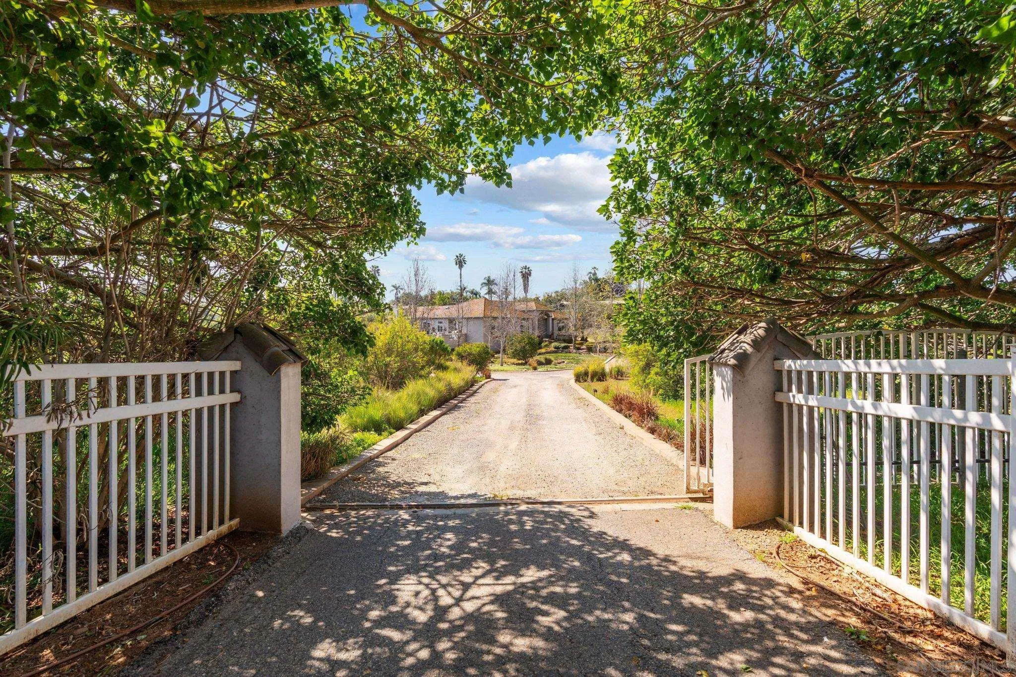 1035 Sleeping Indian Road Oceanside, CA 92057 - Photo 22 of 22 a view of a entrance to a house with wooden fence
