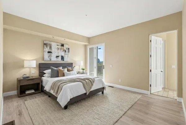 a bedroom with a bed and a painting on the wall