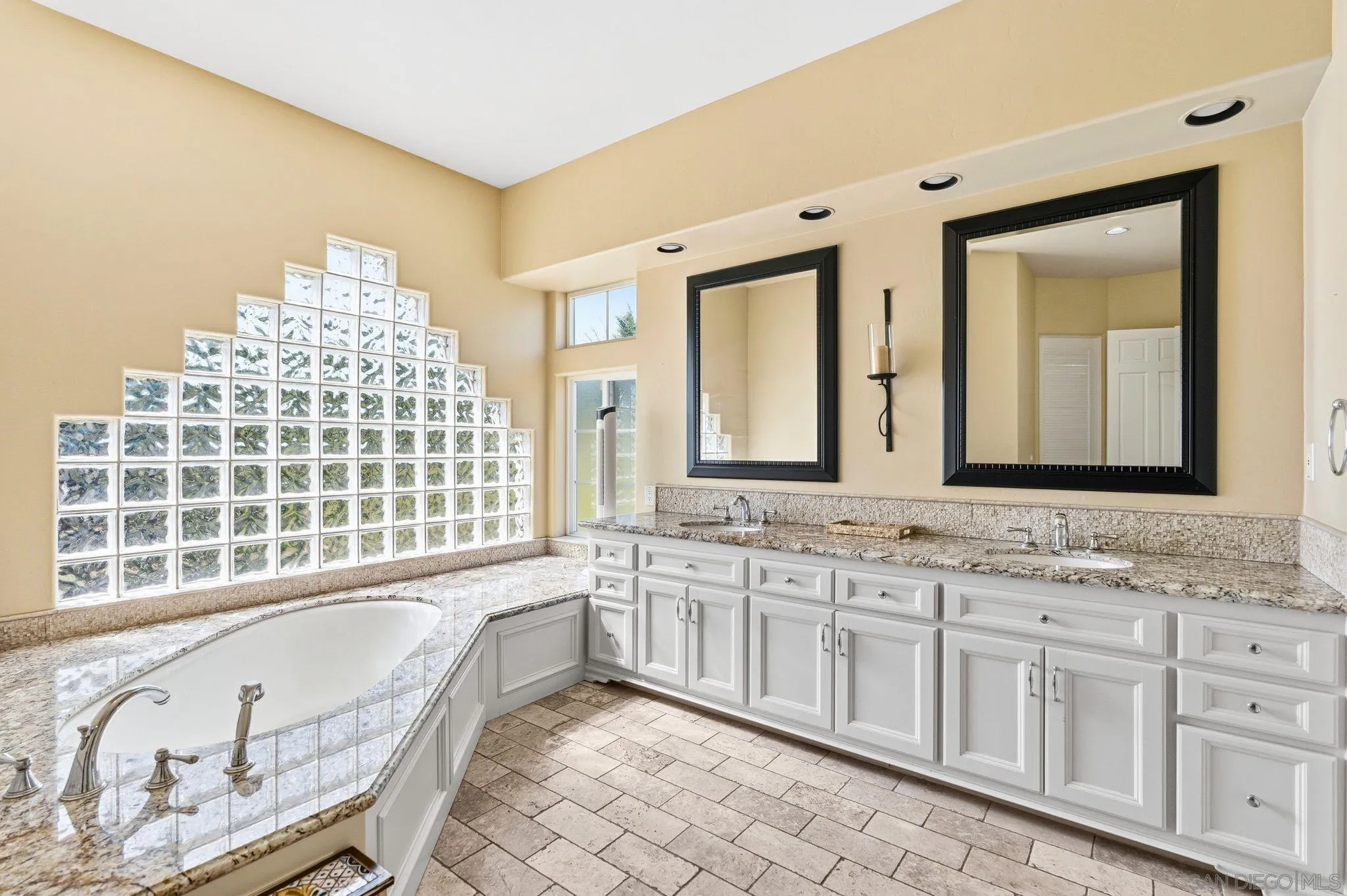1035 Sleeping Indian Road Oceanside, CA 92057 - Photo 8 of 22 a bathroom with a granite countertop double vanity sink a mirror and a bathtub