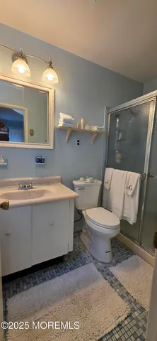 a bathroom with a toilet a sink and mirror