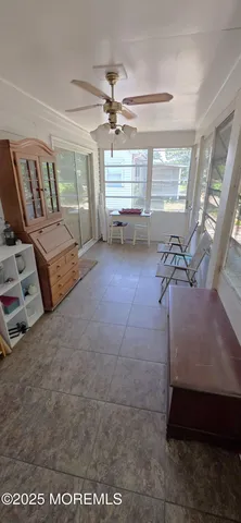 a living room with furniture and large window