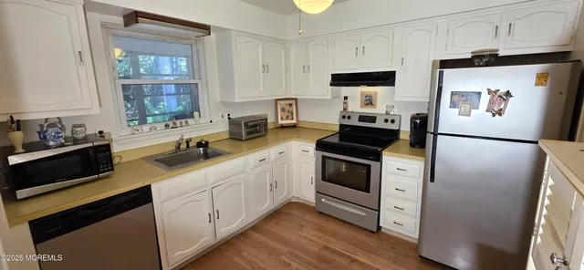 a kitchen with stainless steel appliances a stove sink and refrigerator