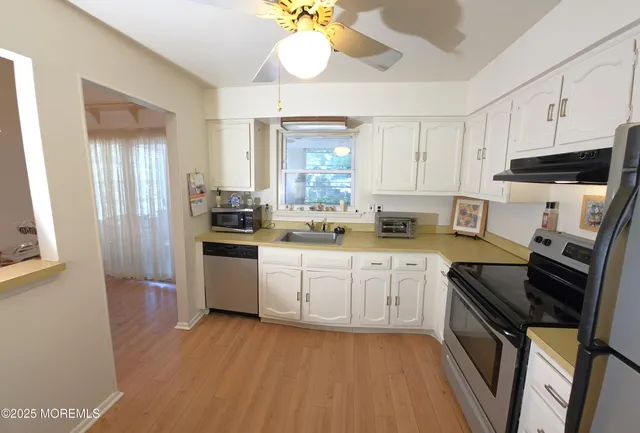 a kitchen with a sink stove and refrigerator