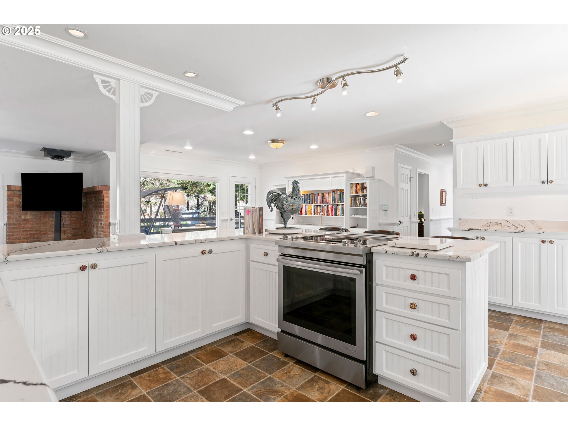 9202 Phey Lane Florence, OR 97439 - Photo 12 of 47 a kitchen with stainless steel appliances kitchen island granite countertop a stove a sink and a microwave